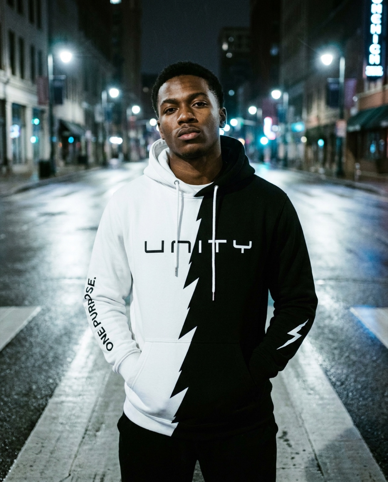 UNITY split hoodie worn at night in an empty city street